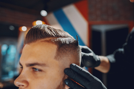 Stylish man sitting in a barbershopの写真素材