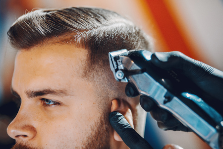 Stylish man sitting in a barbershopの写真素材