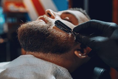Stylish man sitting in a barbershopの写真素材