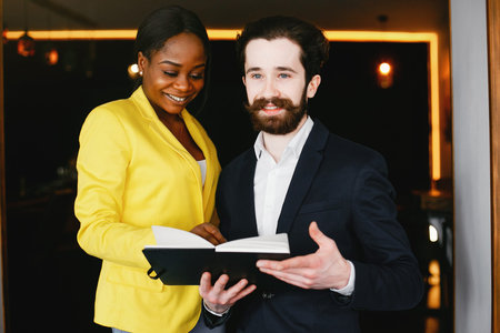 Stylish businessman working in a office with partnerの写真素材