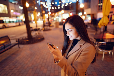 Fashion girl walking in a evening cityの写真素材