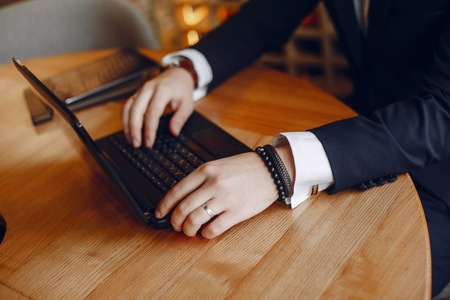 Stylish businessman working in a cafeの写真素材