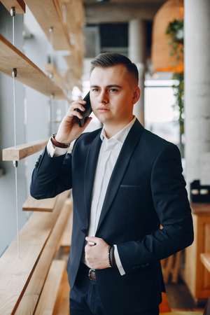 Stylish businessman working in a officeの写真素材