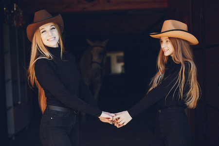 Elegant girls with a horse in a ranchの写真素材