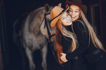 Elegant girls with a horse in a ranchの写真素材