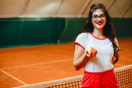 Beautiful and stylish girl on the tennis courtの写真素材