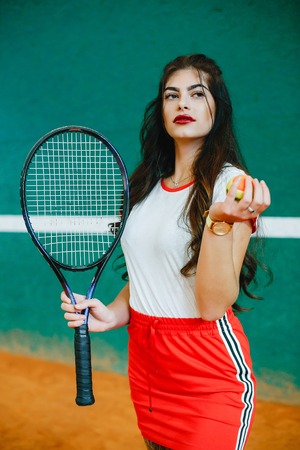 Beautiful and stylish girl on the tennis courtの写真素材