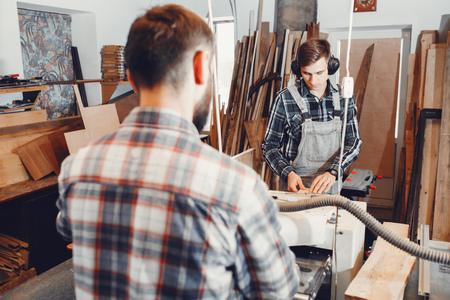 The carpenter works with a treeの写真素材