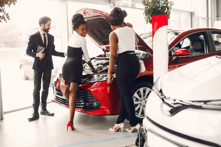 Two stylish black woman in a car salonの写真素材