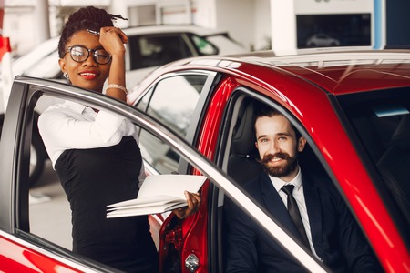 Stylish black woman in a car salonの写真素材