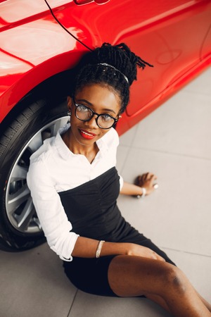 Stylish black woman in a car salonの写真素材