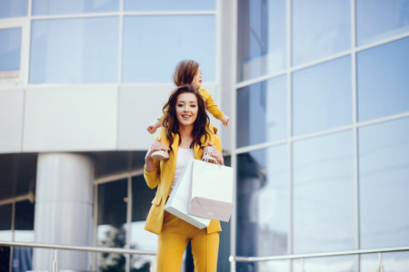 Mother and daughter with shopping bag in a cityの写真素材