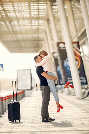 Beautiful couple standing in a airportの写真素材