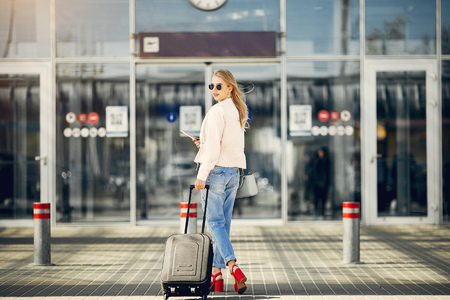 Beautiful girl standing in a airportの写真素材