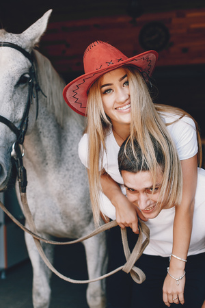 Beautiful couple spend time with a horsesの写真素材