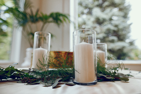 Beautiful white candles. Elegant wedding with white candles and flowersの写真素材