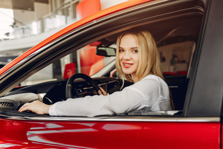 Stylish and elegant woman in a car salon