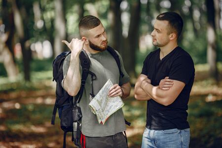 Two friends have a rest in a summer forestの写真素材