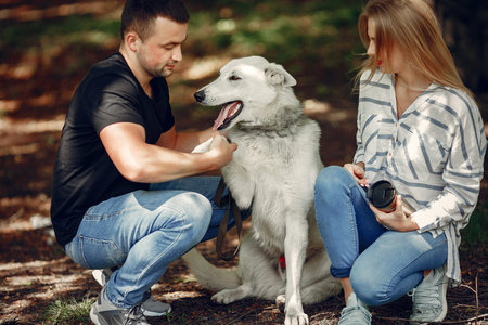 Beautiful couple spend time on a summer forest