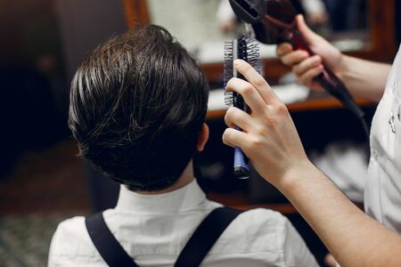 Stylish man sitting in a barbershopの写真素材