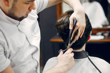 Stylish man sitting in a barbershopの写真素材