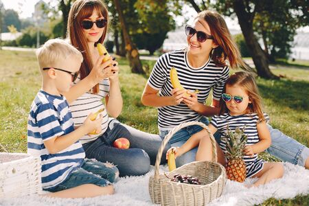 Mothers with kids playing in a summer parkの写真素材