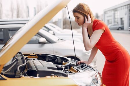 Stylish and elegant woman in a car salonの写真素材
