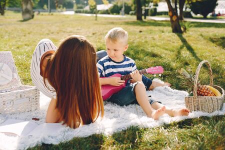 Mother with son playing in a summer parkの写真素材
