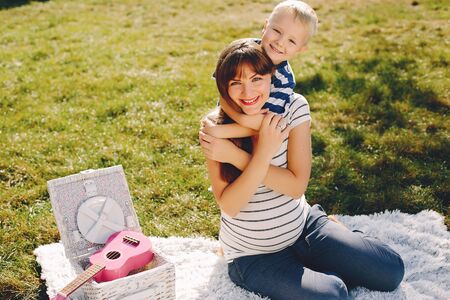 Mother with son playing in a summer parkの写真素材