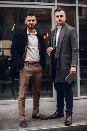 Two businessmen working with a laptopの写真素材