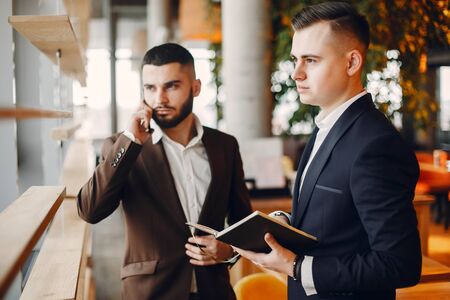 Two businessmen working in a cafeの写真素材