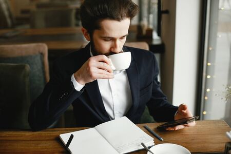Stylish businessman working in a officeの写真素材