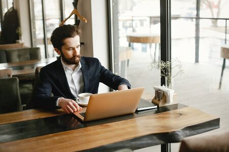 Stylish businessman working in a officeの写真素材