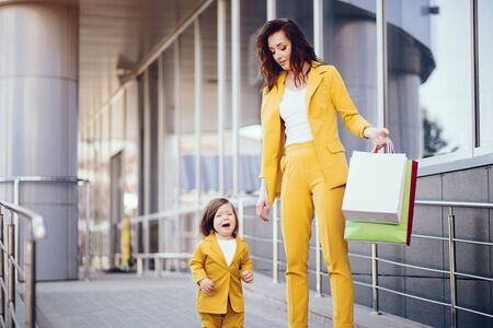 Mother and daughter with shopping bag in a cityの写真素材