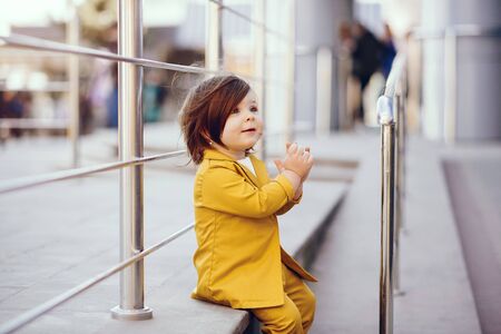Cute little girl with shopping bag in a cityの写真素材