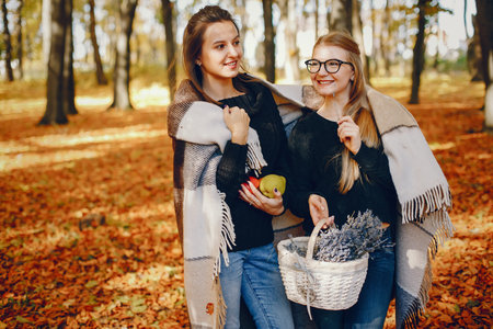 Beautiful girls have fun in a autumn parkの写真素材
