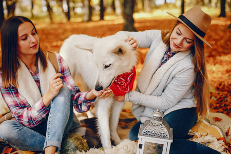 Beautiful girls have fun in a autumn park