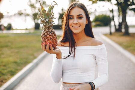 Cute and pretty girl in a summer parkの写真素材