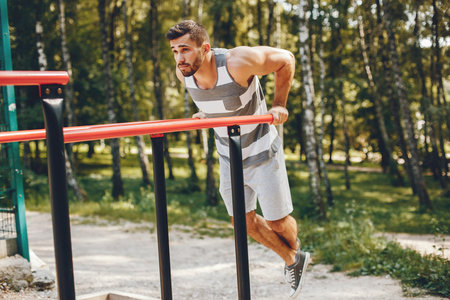 Sports man in a morning summer park