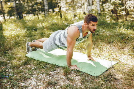 Sports man in a morning summer park