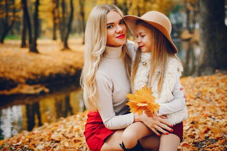 Cute and stylish family in a autumn parkの写真素材