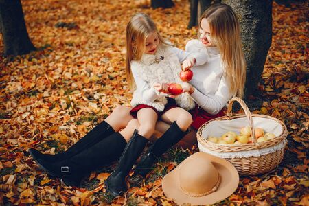 Cute and stylish family in a autumn parkの写真素材