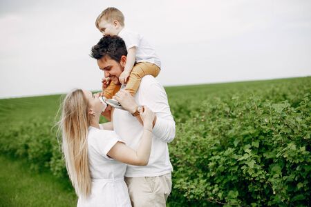 Cute family playing in a summer fieldの写真素材