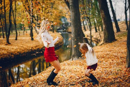 Cute and stylish family in a autumn parkの写真素材
