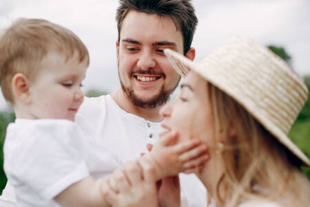 Cute family playing in a summer fieldの写真素材