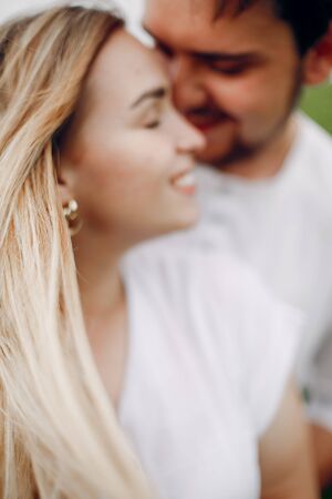 Beautiful couple spend time on a summer fieldの写真素材