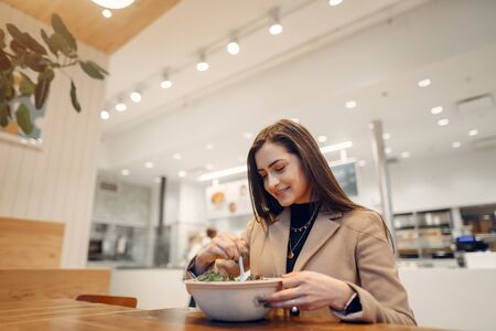Beautiful girl sitting in a cafeの写真素材