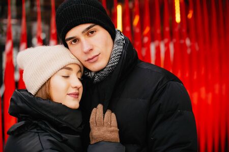 Cute and loving couple in a winter cityの写真素材
