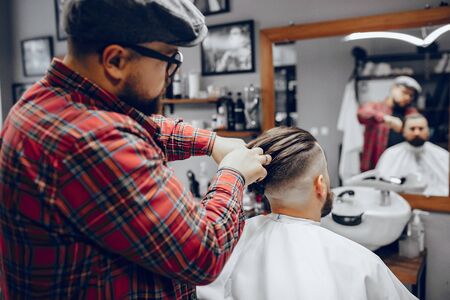 Stylish man sitting in a barbershopの写真素材