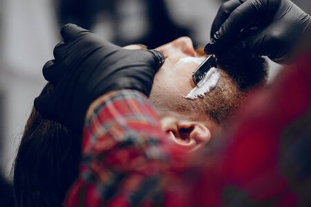 Stylish man sitting in a barbershopの写真素材